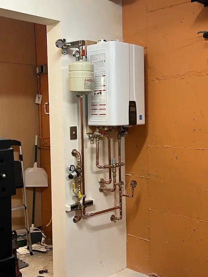 Plumbing technician inspecting water heater connections in Lakewood Ranch